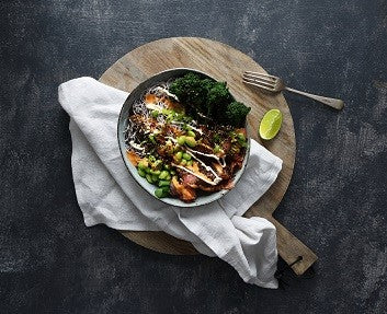 Salmon and seaweed warm poke bowl with spicy peanut sauce